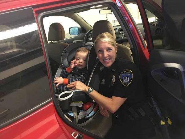 An EPPD officer with a child in a car seat