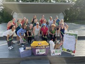 photo of group participating in previous POUND for PROP event, along with their donations