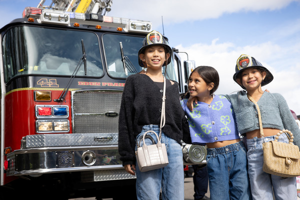 Three girls in front of an Eden Prairie fire truck during Citywide Open House
