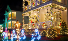 White holiday lights and red ribbons on house