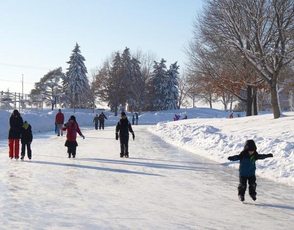 Kids and adults skating on the outdoor rink at Staring Lake Park during Winter Blast