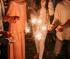 Close up of hands holding up sparklers