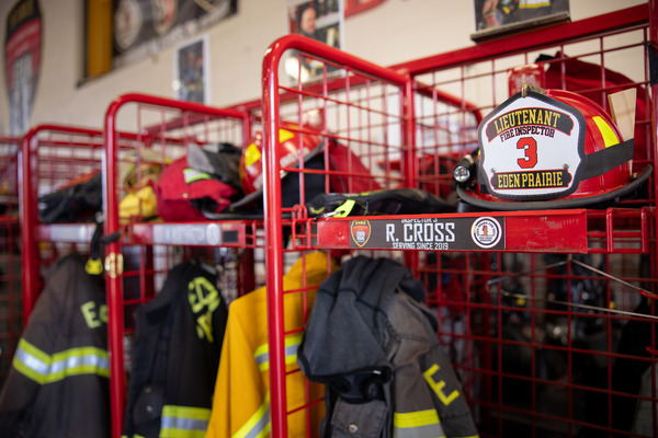 Red wire lockers inside a fire station hold firefighting gear.