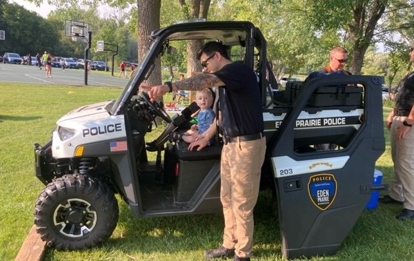 An EPPD officer speaks with a child sitting in an EPPD vehicle