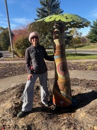 Artist next to Senior Center art installation