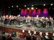 Community band on stage during a holiday concert