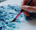 close-up of hand painting with watercolors