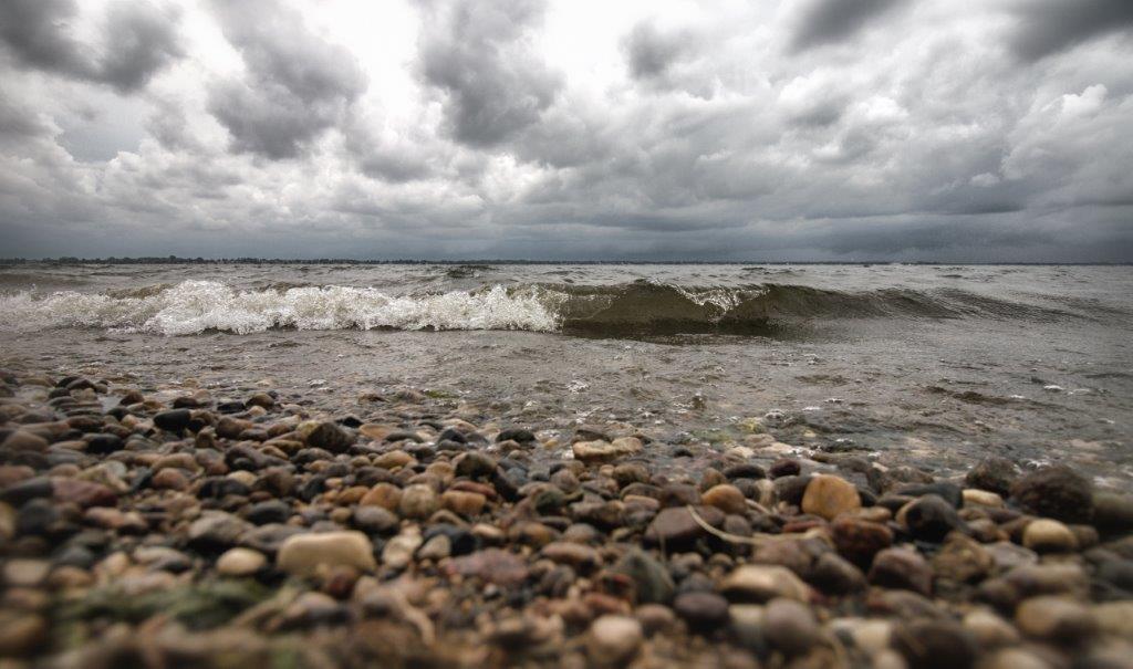 Lake Superior shoreline, large waves, and stormy sky. Entitled a coming storm, by Scott.