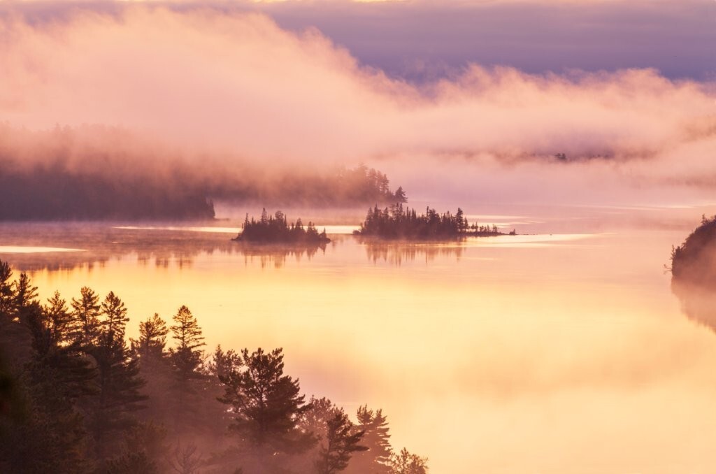 Islands in early morning fog on a Boundary Waters lake in northern Minnesota during autumn