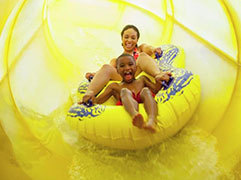 Mother and son go down a waterslide
