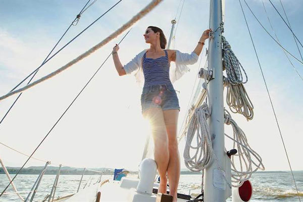 woman standing on sailboat