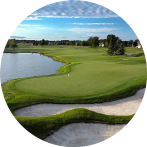 A golf course with lakes and sand dunes in the foreground