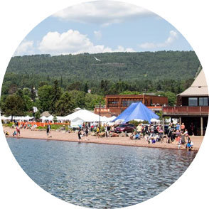 Festival tents and a crowd along the Grand Marais shoreline