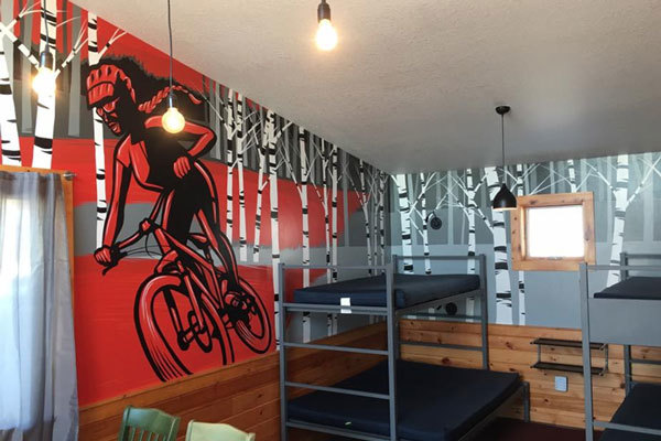 Modern cabin interior painted with a mural of a bicyclist