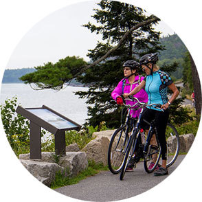 Two bicyclists take a break at a lake