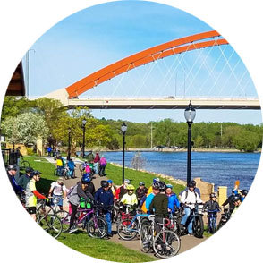 group of bicyclists poses on the hastings riverfront