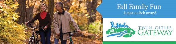 man and woman walk bikes together