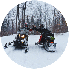 Snowmobilers high fiving