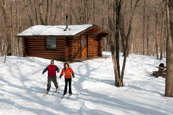 an image of cross-country skiers and camper cabins at Lake Maria State Park