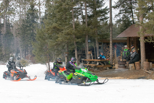 image of snowmobilers  on a Grand Rapids area trail