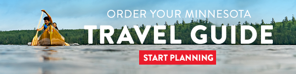 Two people canoeing on crystal-clear lake, with text reading: Order your Minnesota Travel Guide