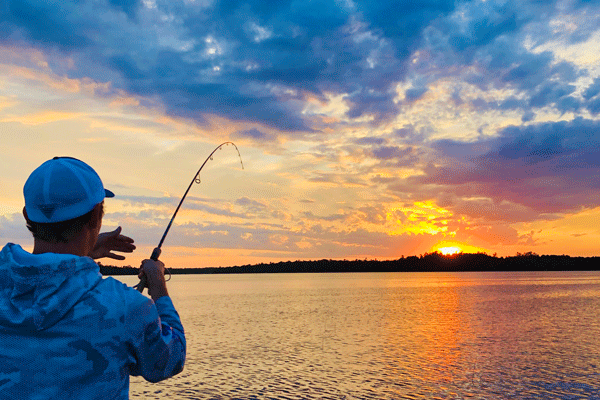 an image of an angler fishing at sunset