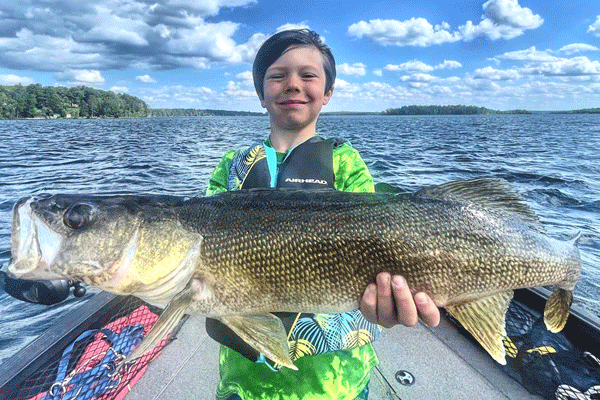 an image of a young boy and his huge walleye