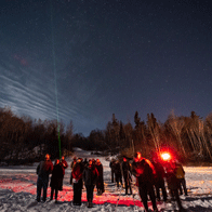 an image of people gazing at the night sky in winter