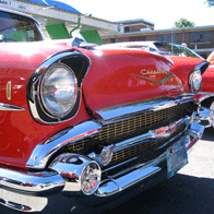 an image of the front of an old red car