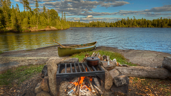 an image of a campfire and canoe on Caribou Lake in the BWCAW