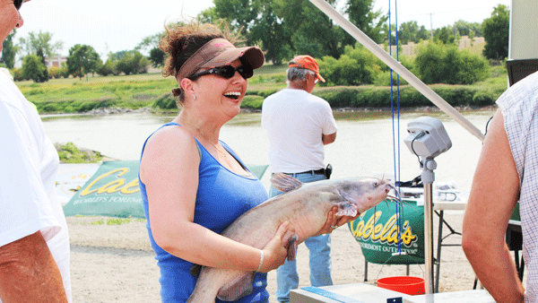 an image of a woman with a catfish she caught during a catfish tournament on the Red River