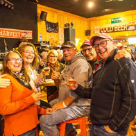 an image of people celebrating with drinks at the Harvest Moon Festival