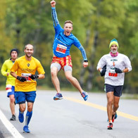 an image of runners surrounded by colorful trees