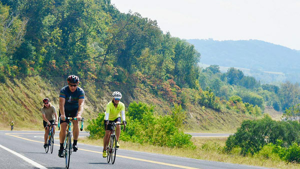 an image of bike racers surrounded by bluffs