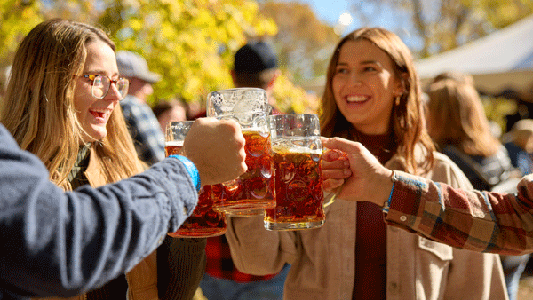 an image of friends cheering with mugs of beers at an Oktoberfest celebration at Schells Brewery / Paul Vincent
