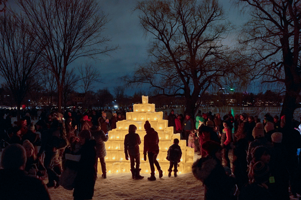 an image of a people admiring a glowing ice sculpture at night during the Luminary Loppet in Minneapolis - courtesy of Paul Vincent