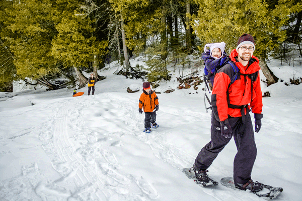 an image of a family snowshoeing on trails along the Cascade River near Lake Superior