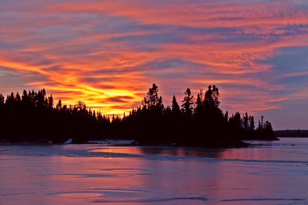 An image a winter sunset on Homer Lake in the Boundary Waters Canoe Area Wilderness by Scott Slocum