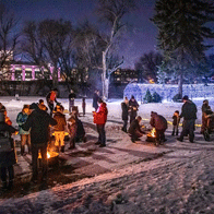 an image of people around bonfires in winter at night