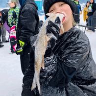 an image of a boy pretending to eat a fish