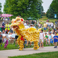 an image of a giant puppet in a park surrounded by people