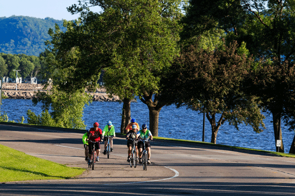 an image of people riding bikes alongside the Mississippi River