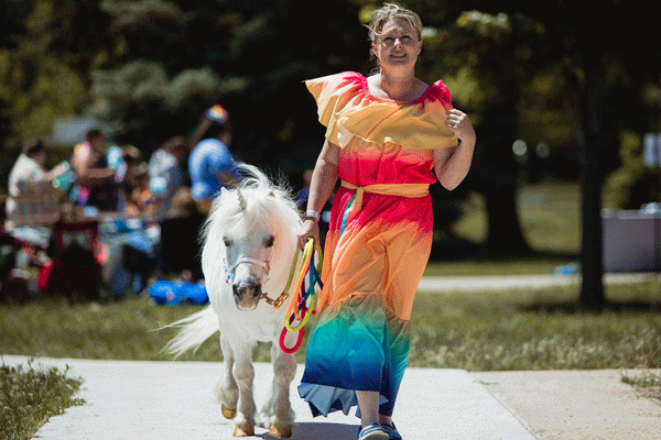 an image of a woman and pony dressed up as a unicorn at Marshall Pride