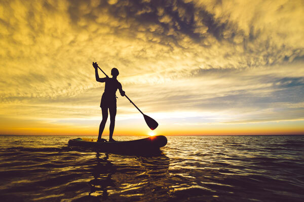 A woman paddle boarding in Duluth