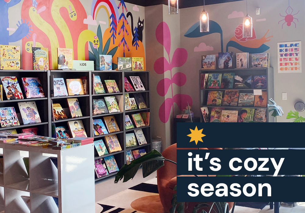 A photo of one mural inside Black Garnet Books in St. Paul, text reads "it's cozy season"