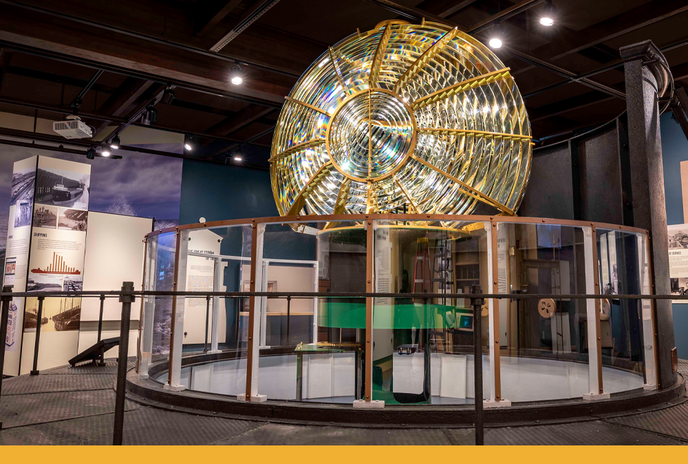 the fresnel lens replica in the latest exhibit. a series of circular ridges can be seen, similar to a vinyl record, on the thin but enormous lens.