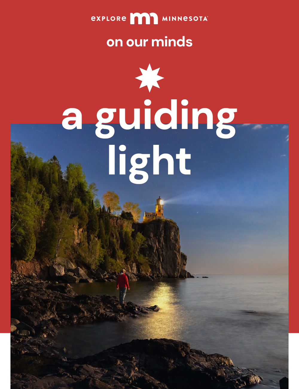 explore minnesota | on our minds | a guiding light | a man walks at dusk on the rocky beach towards a beaming split rock lighthouse above.