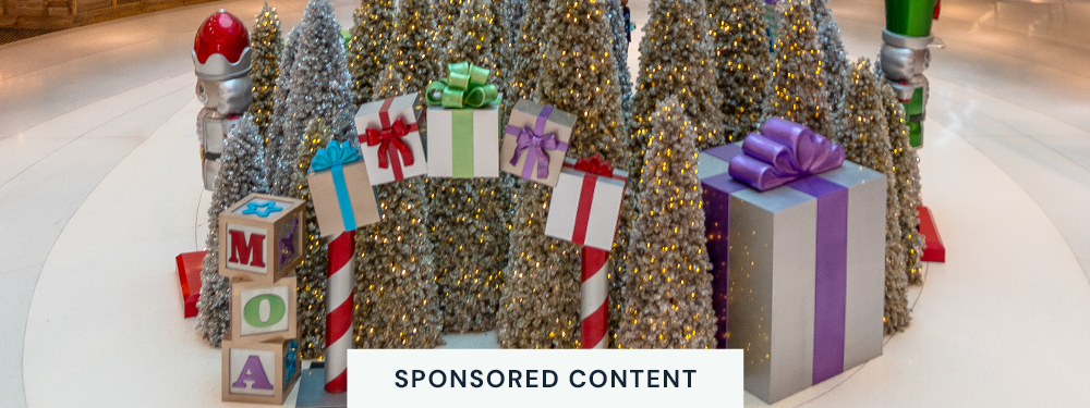 sponsored content: downward view of a mall rotunda filled with large nutcrackers, candy arch, and tree forest