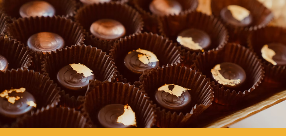 a pan of small chocolate bon bons with gold foil