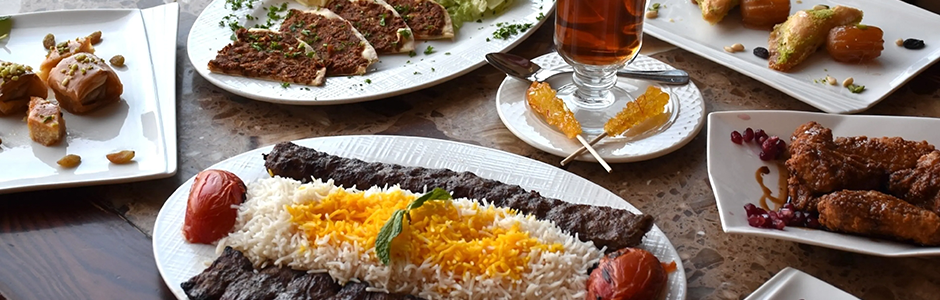 a table filled with meat and rice dishes